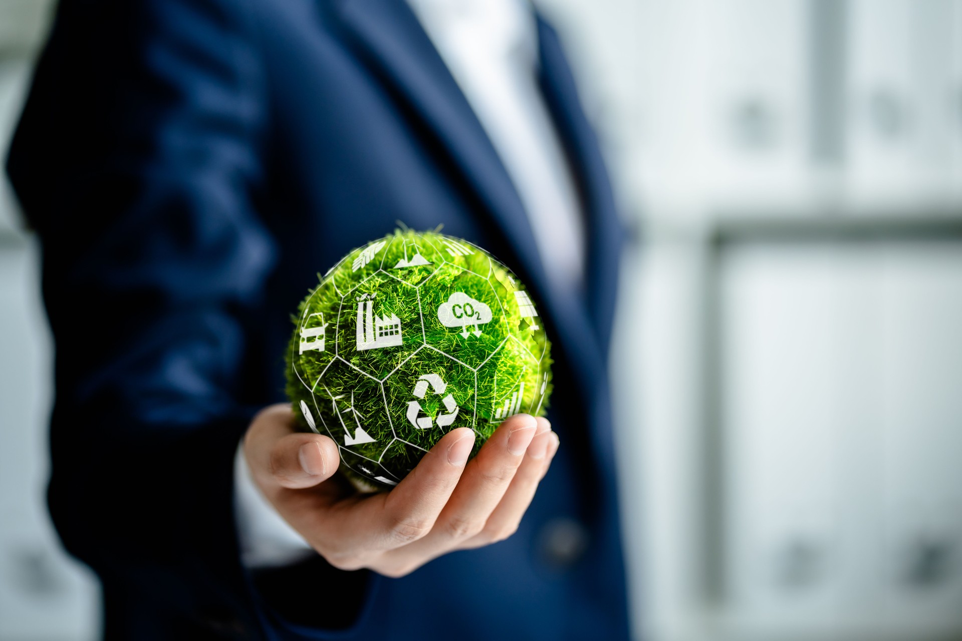Businesswomen holding green ball globe with ESG icon concepts for Environment, Social, Governance, net zero, carbon neutrality goals, development business sustainable environment concept.